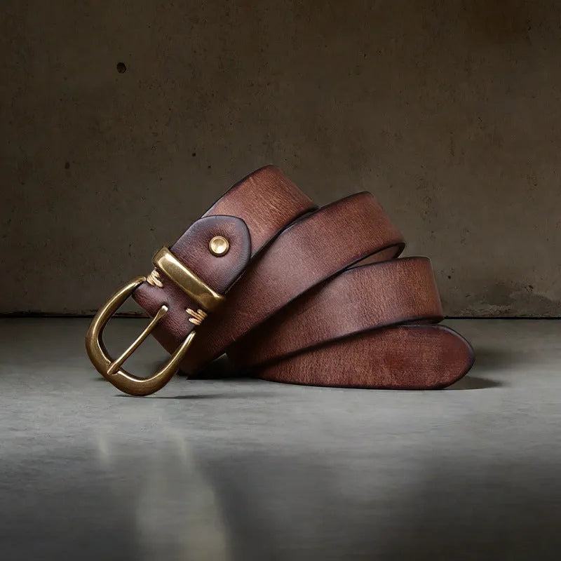 Men's black genuine leather casual belt with a copper pin buckle on a jeans background.