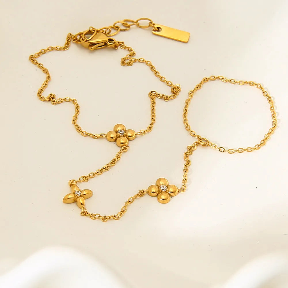 Gold geometric women's bracelet with floral and eight-pointed star design elements