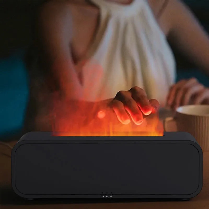 Black USB aroma diffuser with colour-changing LED lights and remote control on a wooden table.