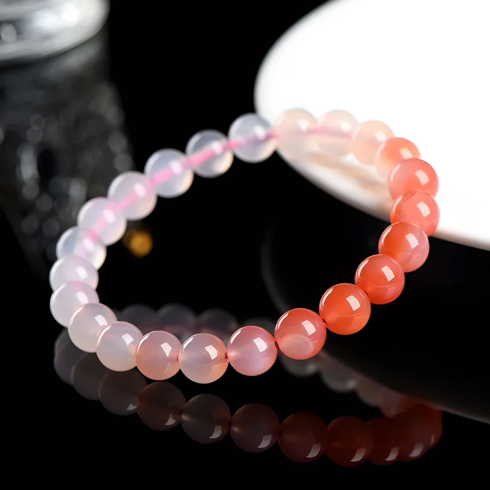 Natural gradient Yanyuan agate bracelet with smooth geometric beads on a wrist.