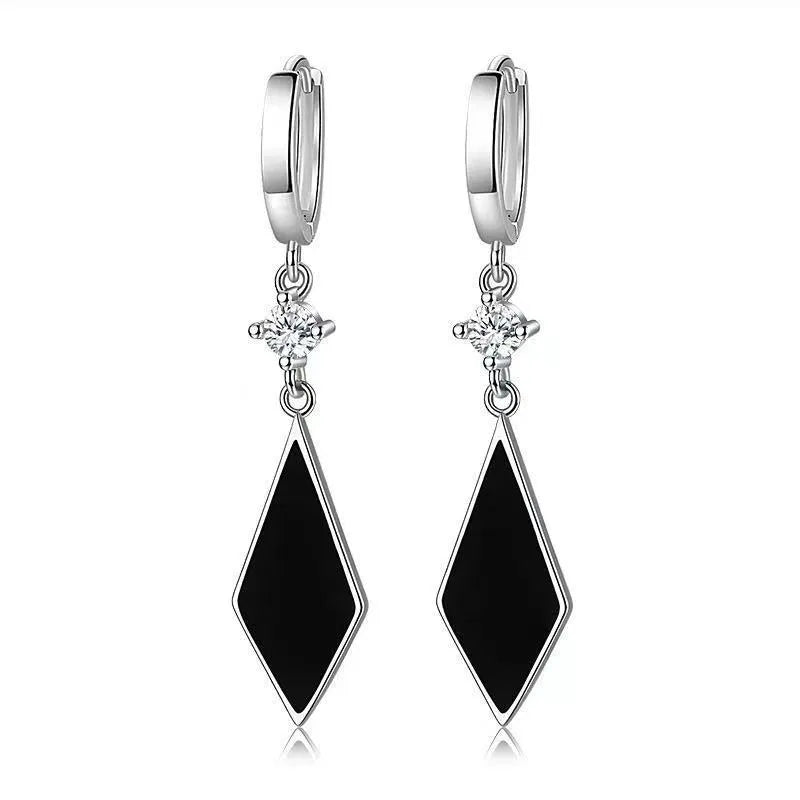 A pair of vintage silver diamond-shaped geometric clip-on earrings made from zinc alloy.