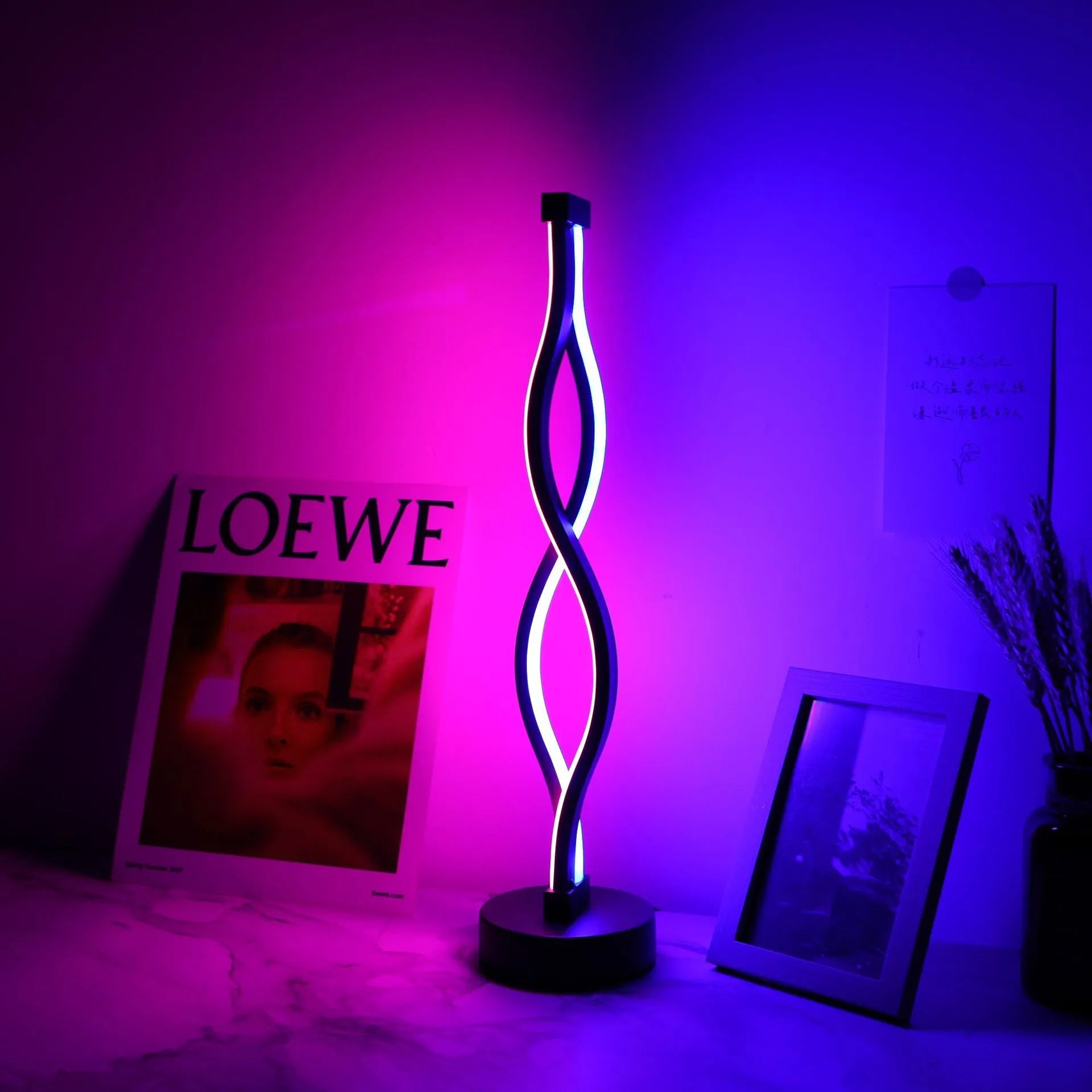 Black aluminium desk lamp with touch dimming button showing three colour temperature settings
