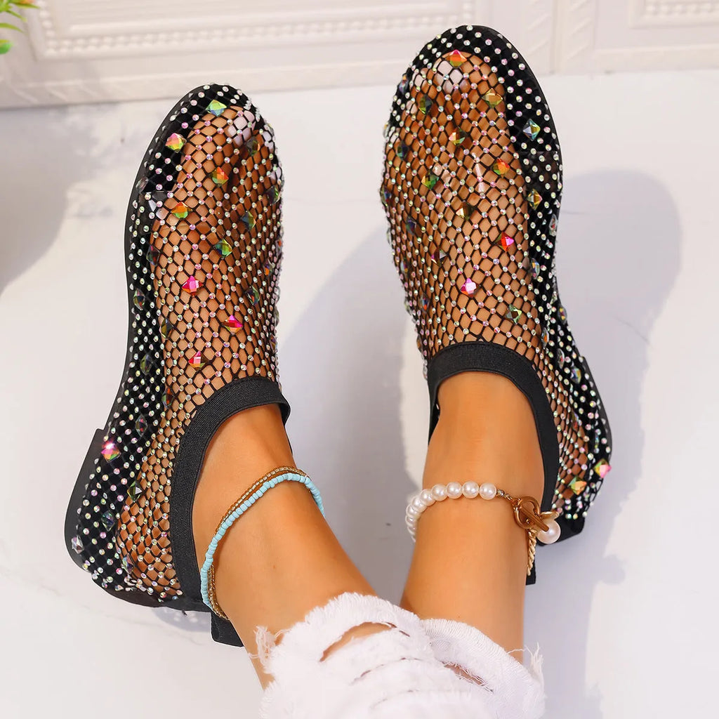 Women's flat sandals with colourful rhinestones on a mesh upper and a rubber sole.