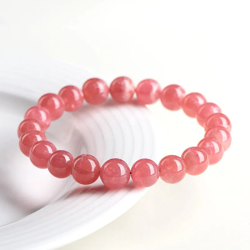 Women's geometric crystal bracelet with rhodochrosite stone and longevity lock in natural red patterns