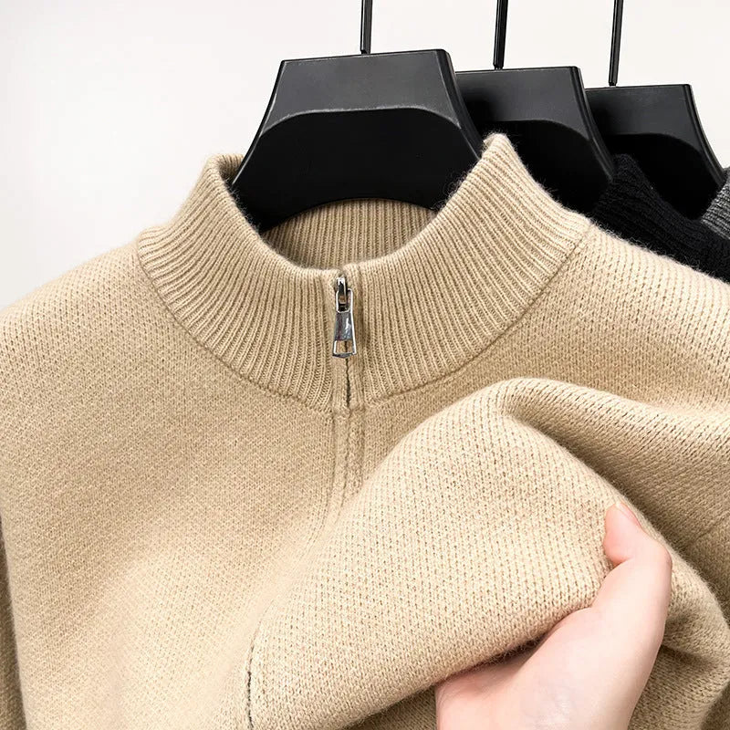 Man wearing a beige stand collar knitted zip cardigan in a loose fit.