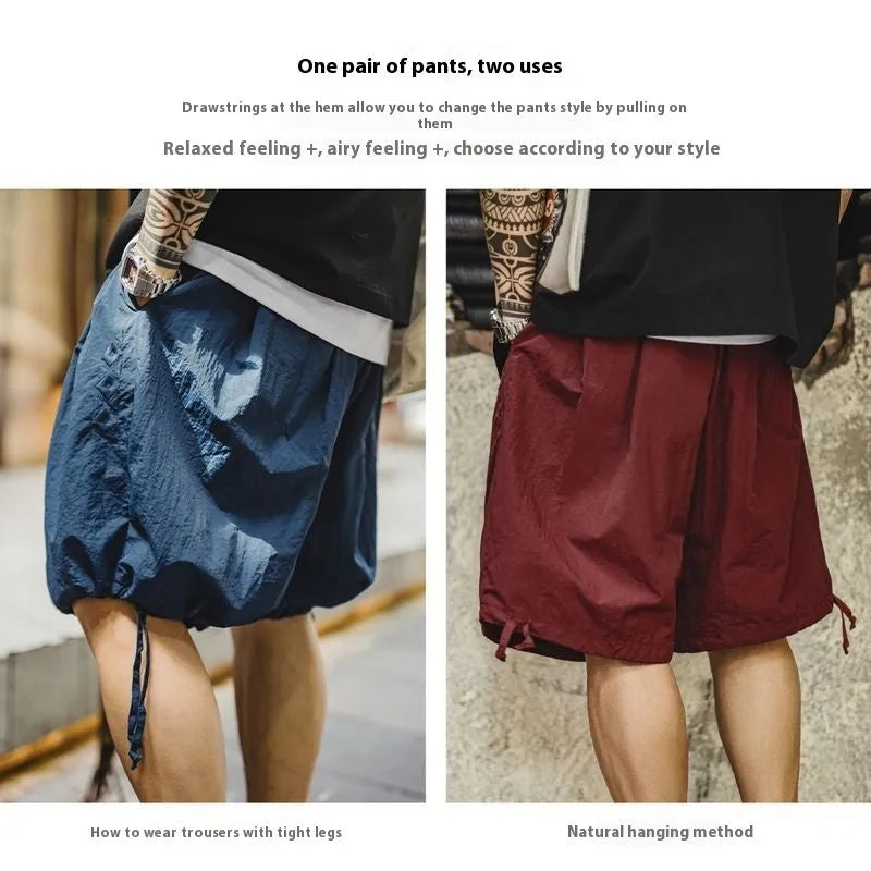 Men's loose Prussian Blue nylon summer shorts showing fifth pants length and non-elastic waistband.