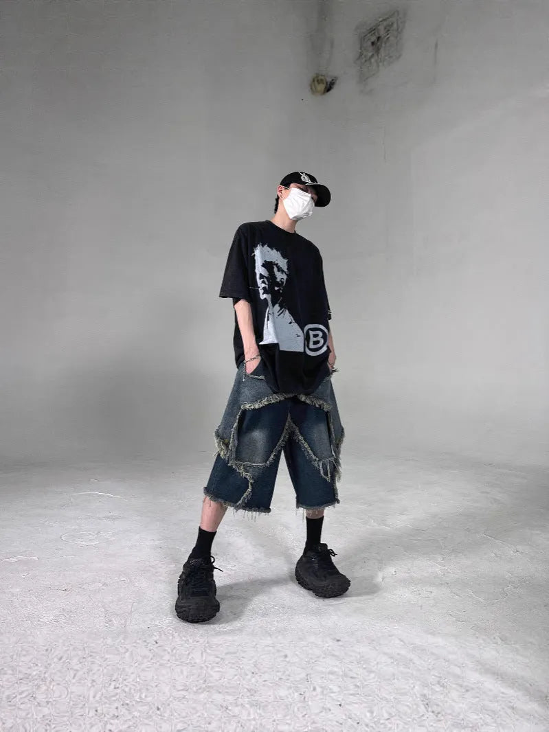 Blue cotton denim shorts for men with frayed hem detailing and five-pointed star patch, loose fit retro style