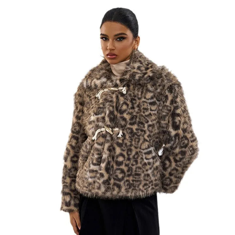 Women's leopard print coat with buckle lapel closure showing regular sleeves and normal length