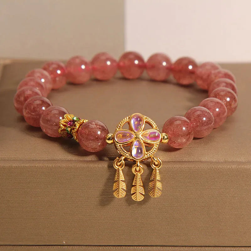 Women's strawberry quartz bracelet with four-leaf dream catcher ball pendant, original crystal jewellery design