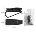 Black plastic multifunctional car mounted glasses and card clip attached to a sun visor holding sunglasses and an ID card