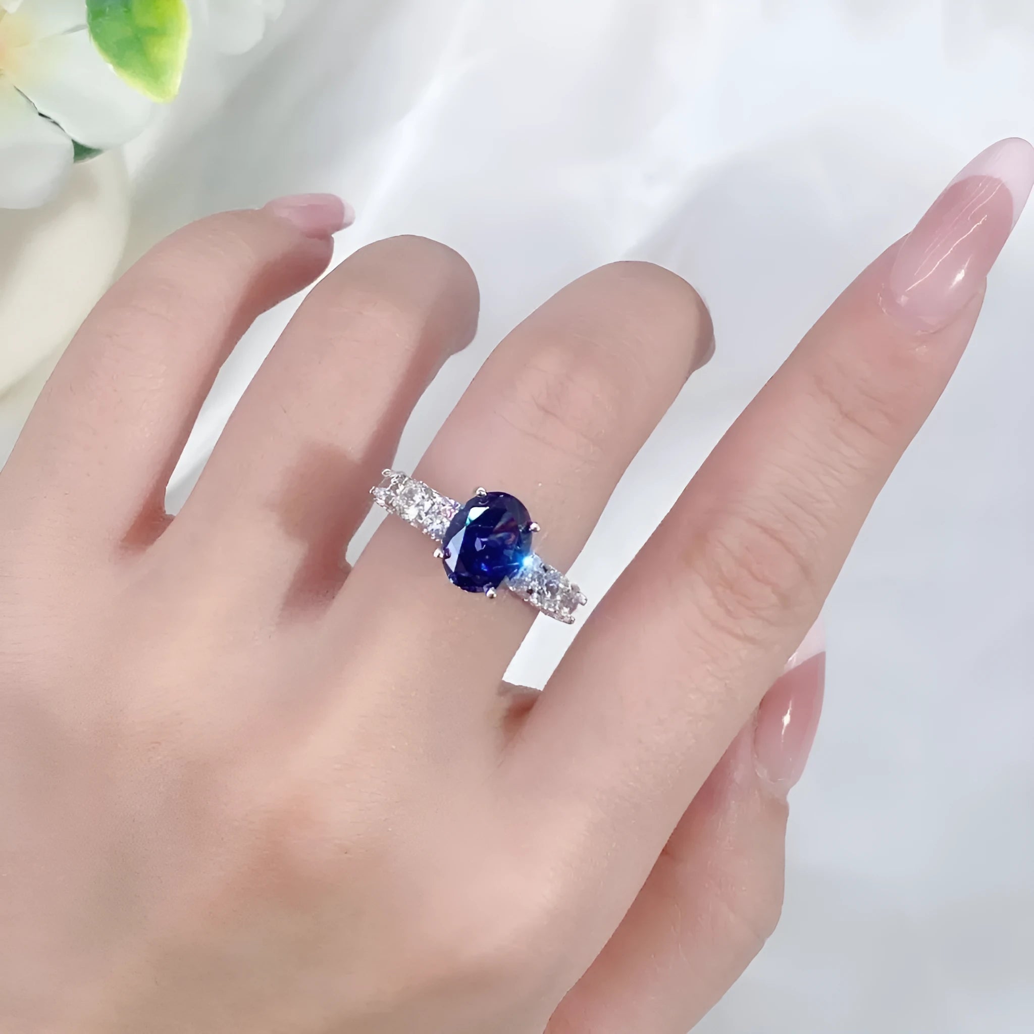 Close-up of a heart-shaped sterling silver ring with a high-carbon diamond ice cut coloured zircon stone.
