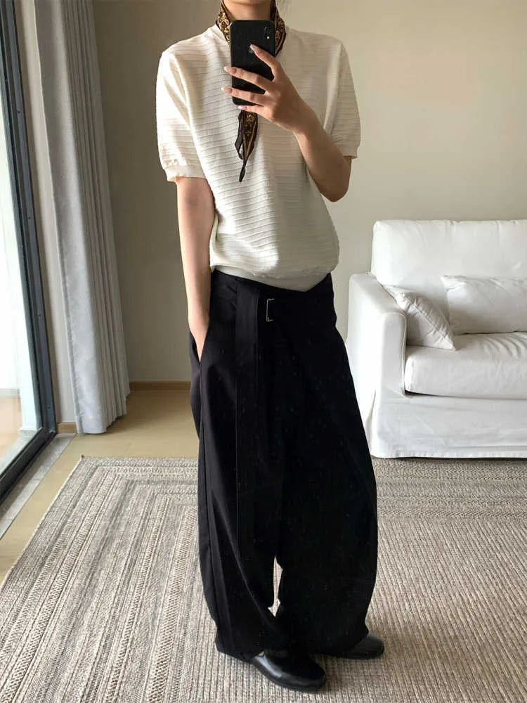 Black straight-leg trousers made from Tencel and cotton blend with a single pleat and adjustable waistband.