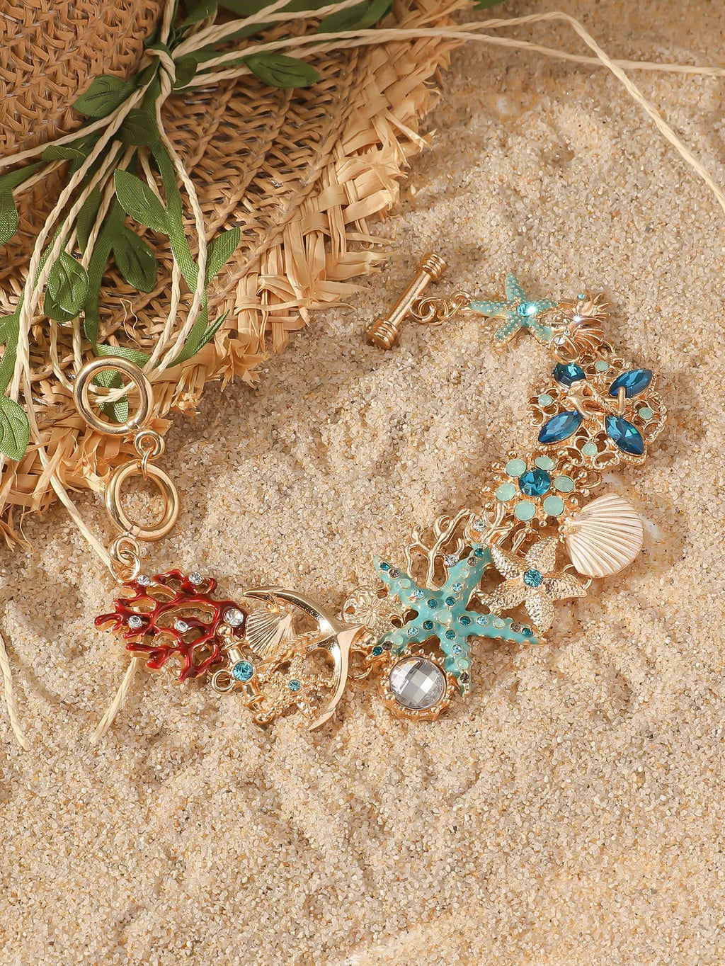 Alloy nautical bracelet with starfish, marine shell and boat anchor charms in turquoise colour