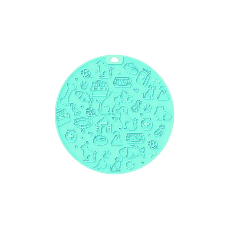 Round blue silicone pet licking mat with a central white suction cup on a kitchen tile.