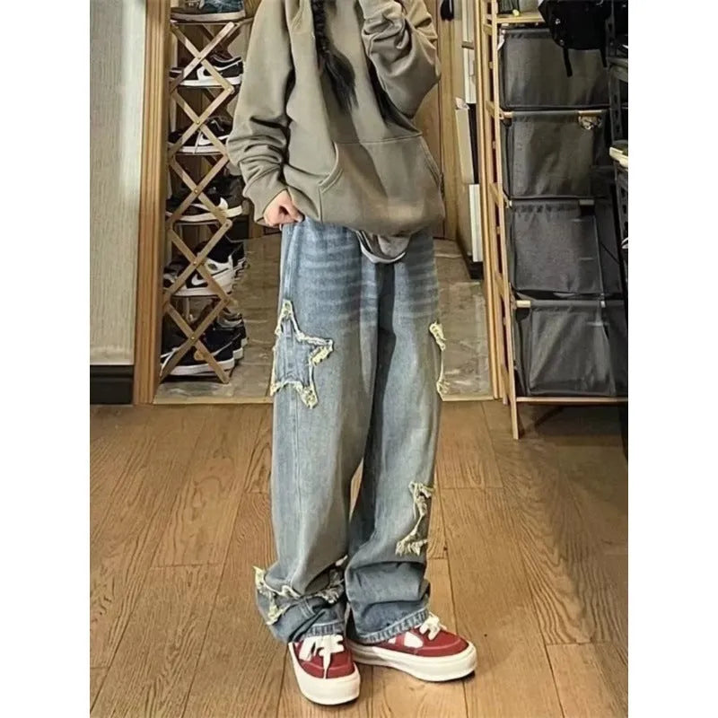 Blue high waist women's denim trousers with a straight wide-leg cut on a size chart.