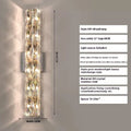 Crystal shade stainless steel wall lamp in chrome finish mounted on a wall.