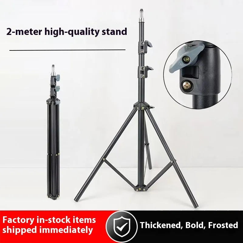 Frosted finish tripod light stand extended to full height with a mobile phone holder attached.