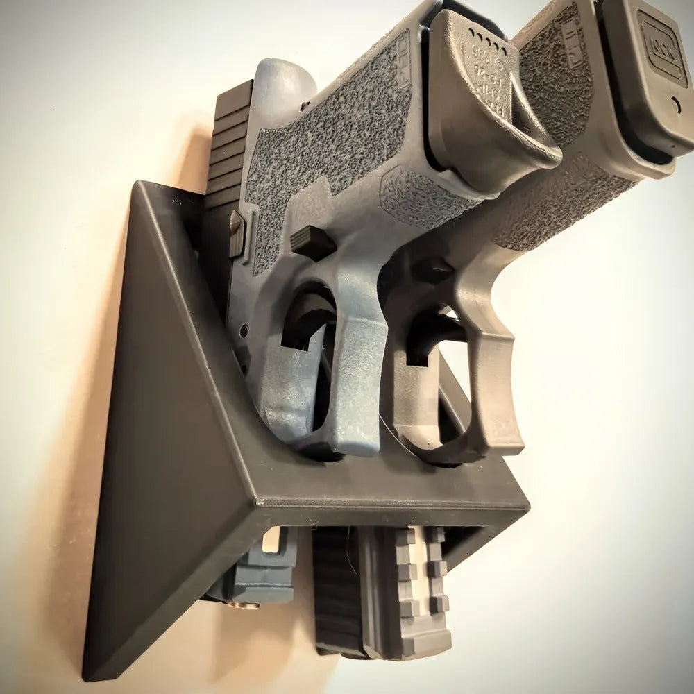 Black punk-style plastic pistol display stand for toy guns and model firearms.