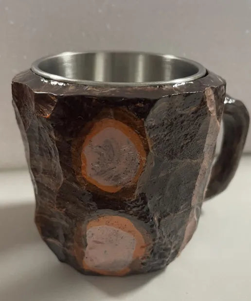 Purple and blue resin coffee mug with crystal texture and handle on wooden table
