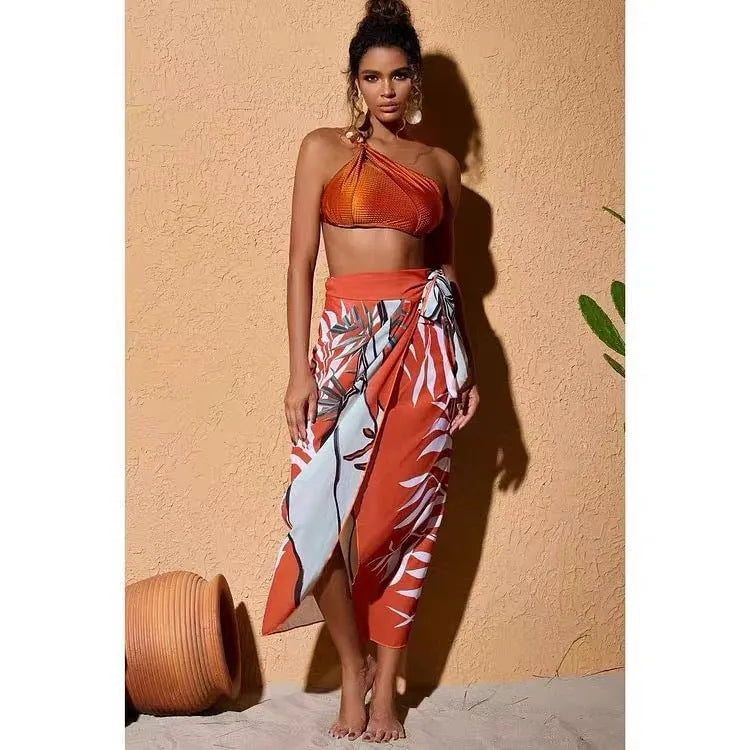 Women's brown high-waist push-up bikini with a sheer split chiffon dress overlay.