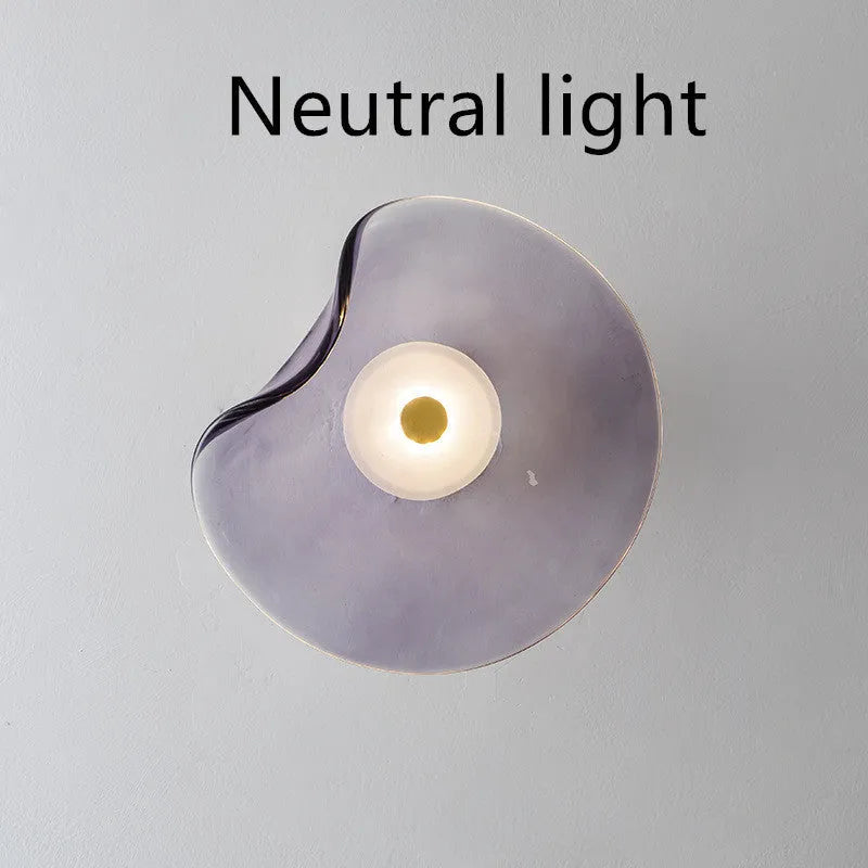 Round decorative wall lamp with glass shade in choice of cognac, light purple, or smoky grey finishes for bedroom lighting