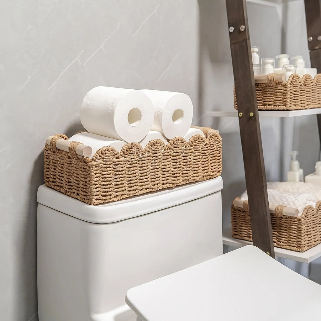 Modern weaved paper storage basket in khaki holding remote controls and stationery on a desktop