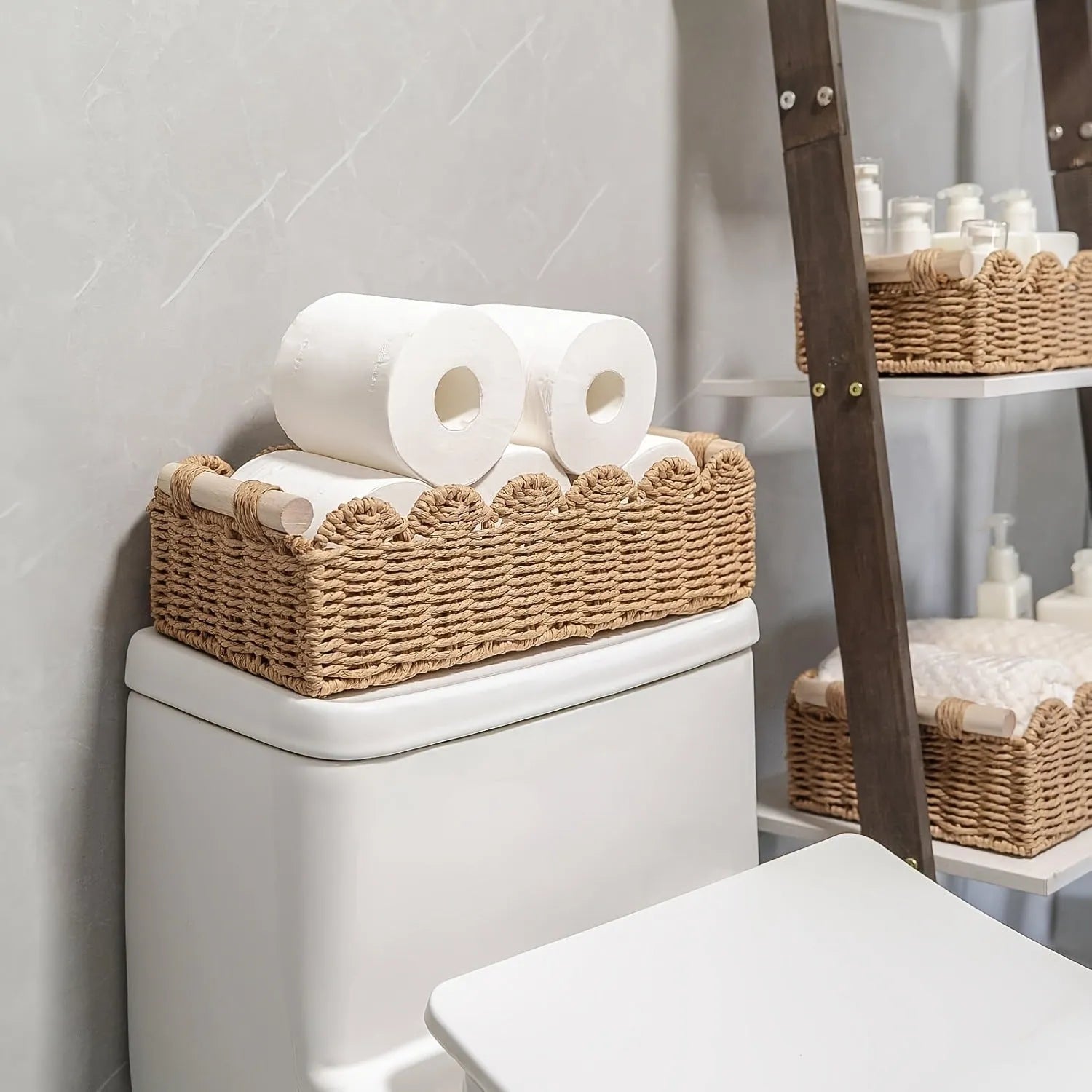 Modern weaved paper storage basket in khaki holding remote controls and stationery on a desktop
