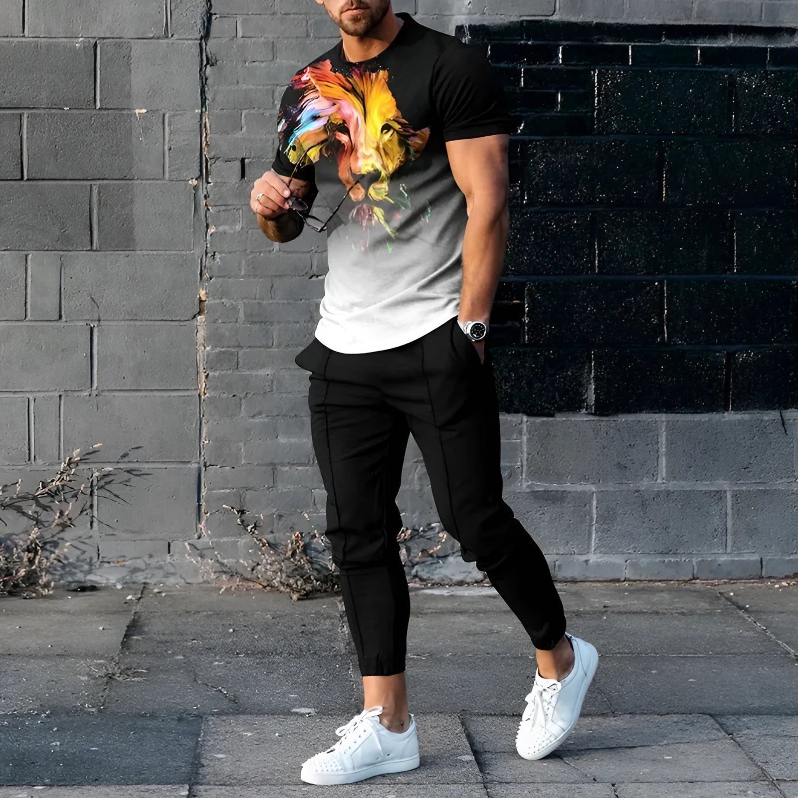 Man wearing a thin, short-sleeved printed pullover and matching trousers from a lightweight sport suit set.