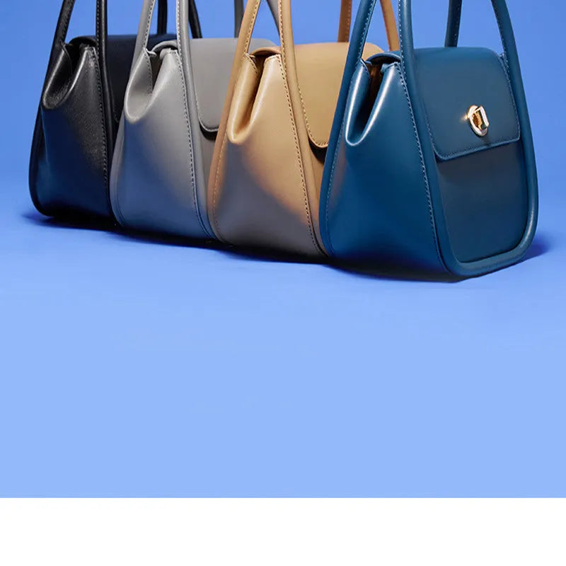 Women's leather wing handbag in blue with buckle decoration and shoulder strap