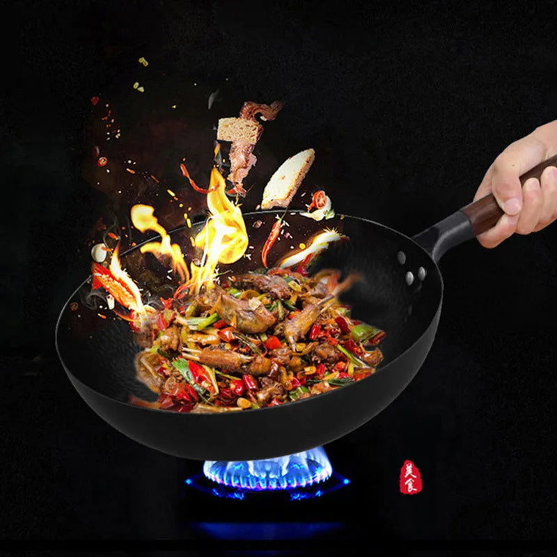 Traditional black iron wok with wooden handle measuring 32cm cooking surface diameter