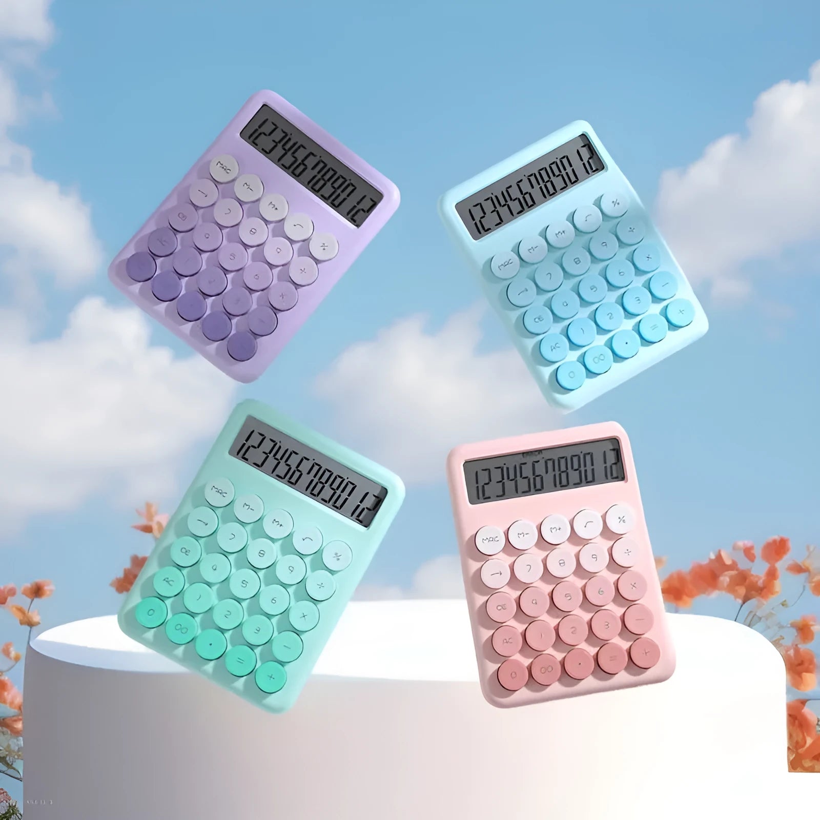 Gradient colour desk calculator in violet, cherry blossom pink, blue, and mint green finishes on a desk.