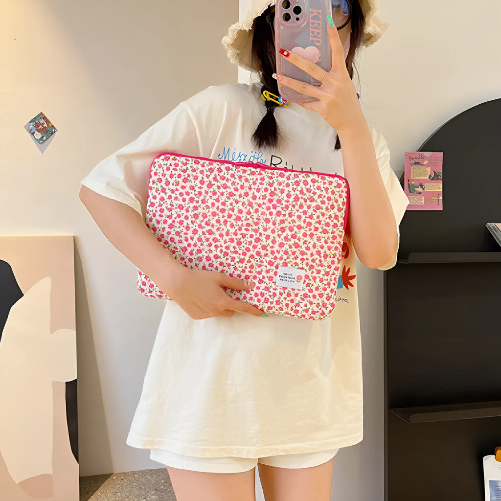 Green floral print cloth laptop bag showing front storage pocket and slim 3cm depth profile.