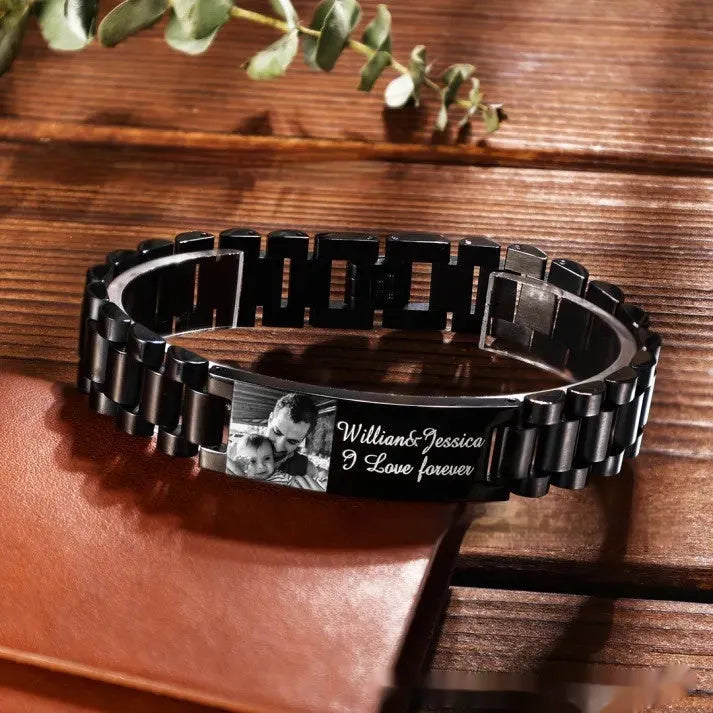 Men's titanium steel bracelet with curved heart shape and black lettering in a gift box.