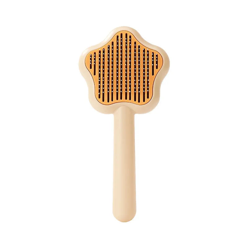 Green and yellow self-cleaning cat comb with stainless steel needles for pet grooming.