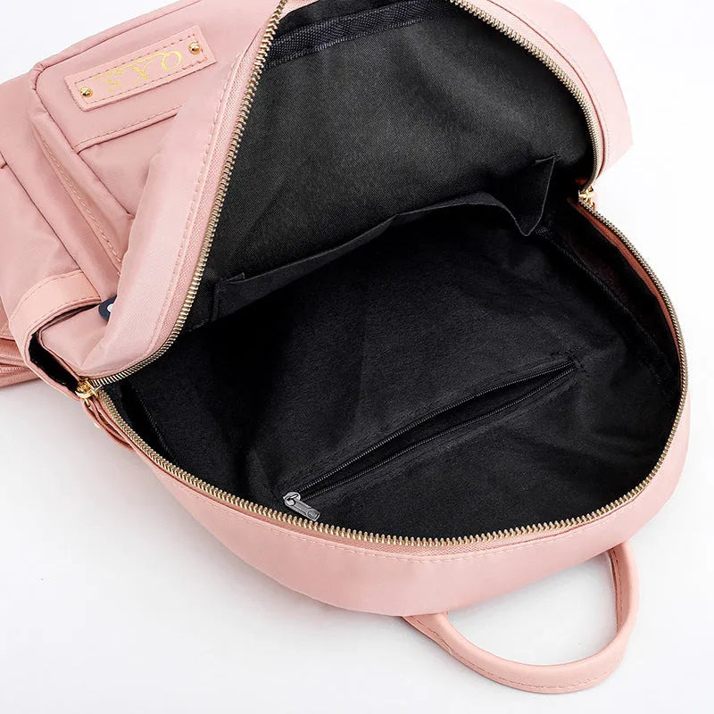 Black or pink casual nylon backpack with waterproof features and organised internal compartments