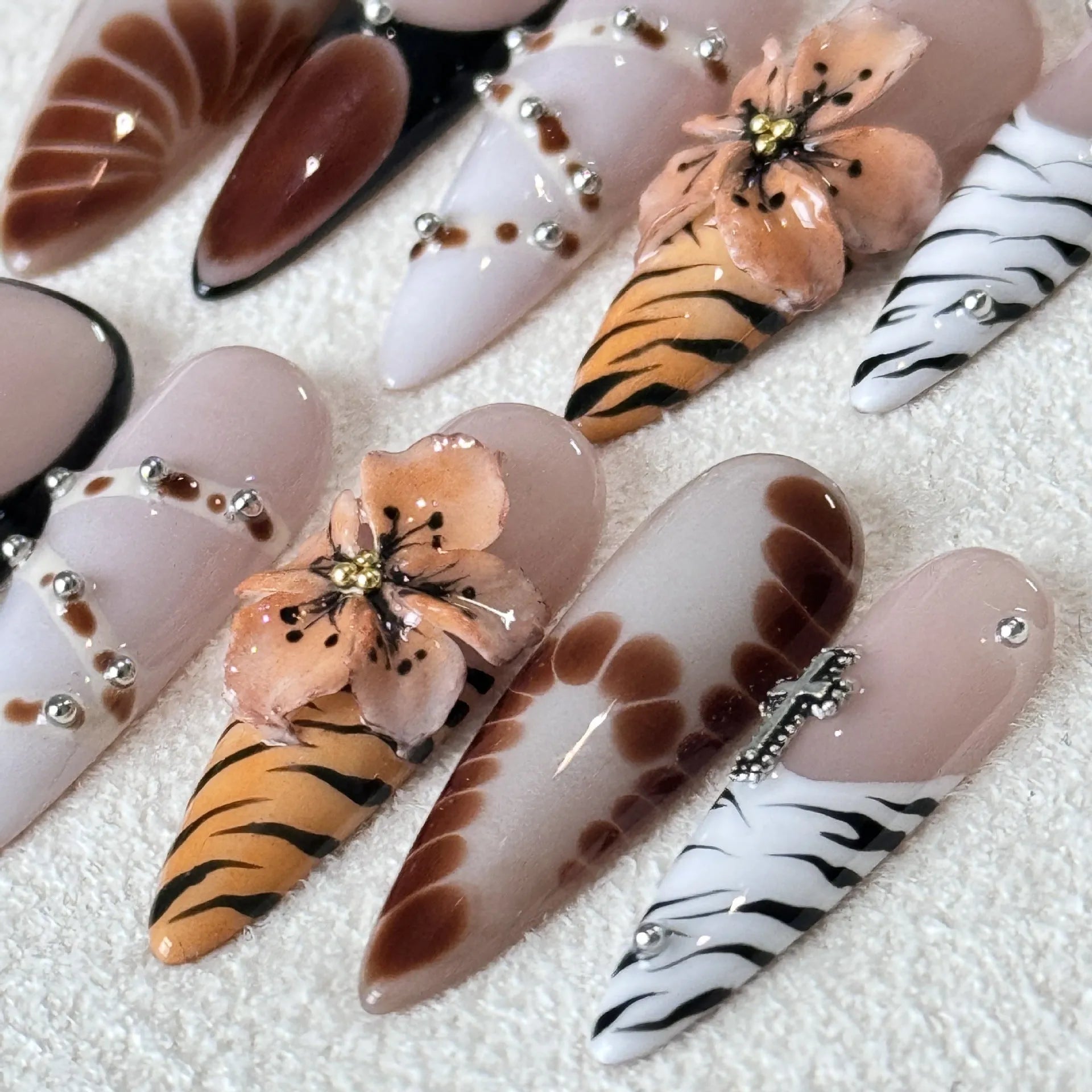 Set of ten French style nail stickers featuring leopard print, cross, and flower patterns in sizes XS, S, M, L.