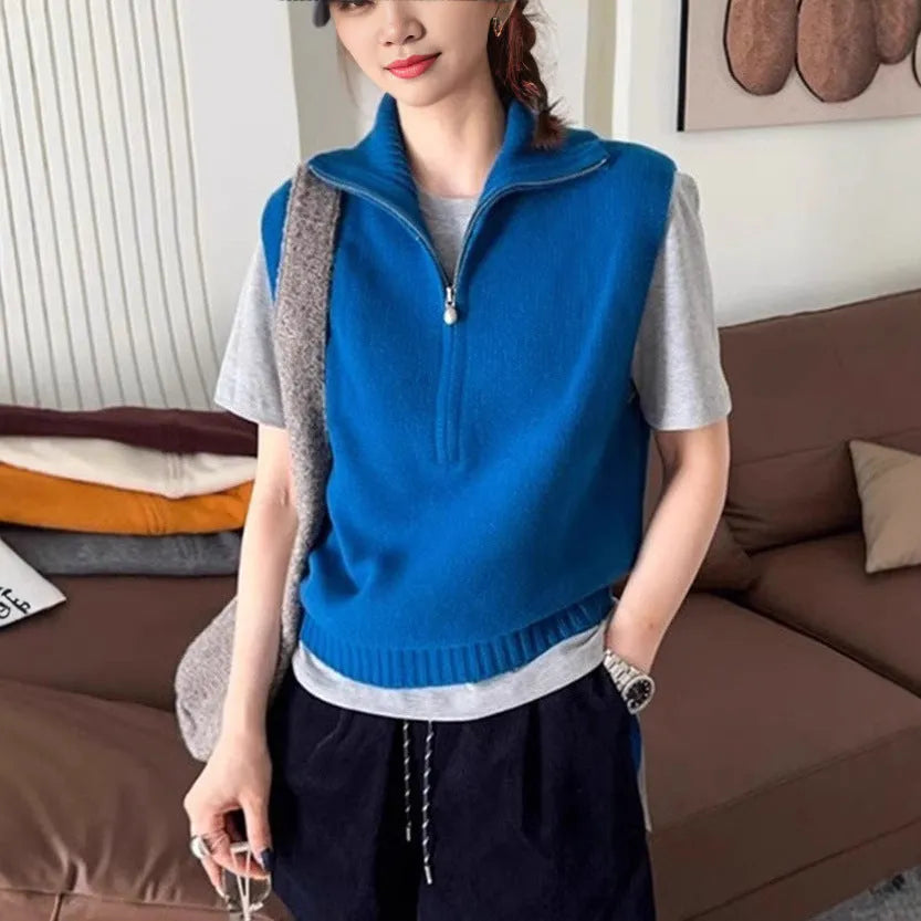 Woman's sleeveless half-zip knit vest with a 3D textured pattern in a solid colour.