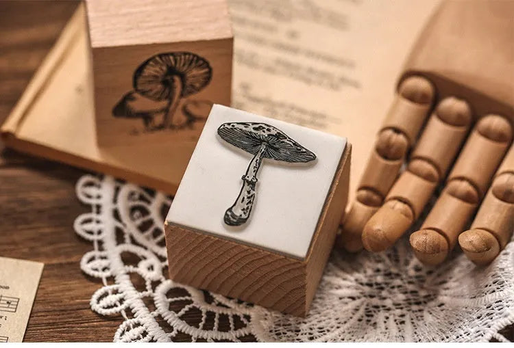 Wooden decorative stamp set with seven hand-carved botanical or celestial designs for paper crafts