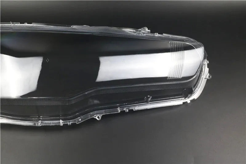 Clear plastic car headlight housing cover with dimensions 50mm by 30mm by 20mm.