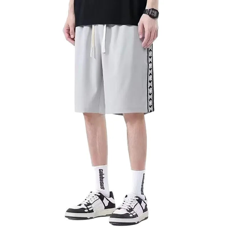 Men's black baggy track pants with loose fit design and elastic waistband for sports wear