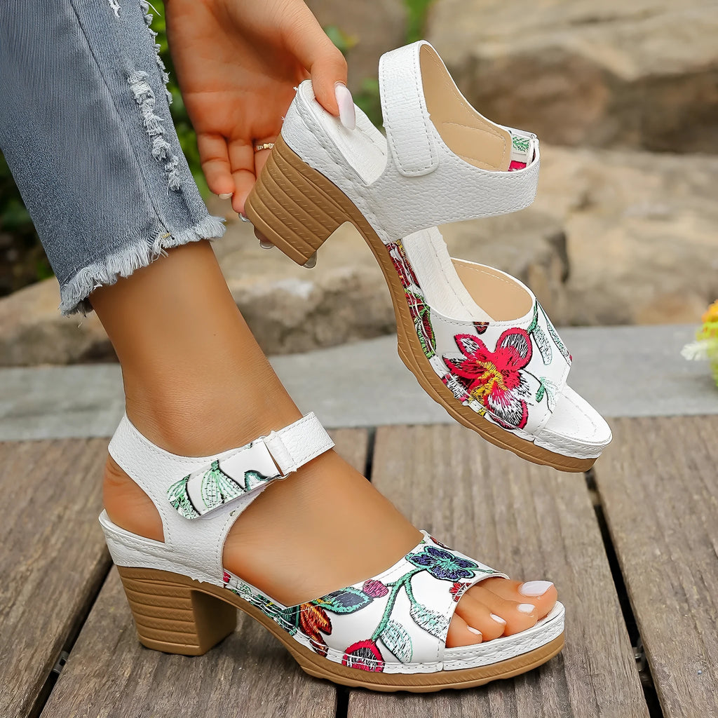 White women's high heel sandals with adjustable Velcro buckle strap on a rubber sole.