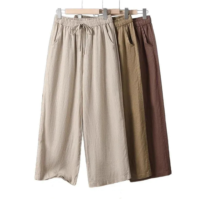 Women's straight-leg casual trousers in apricot colour with elastic waist and lace-up front detail.