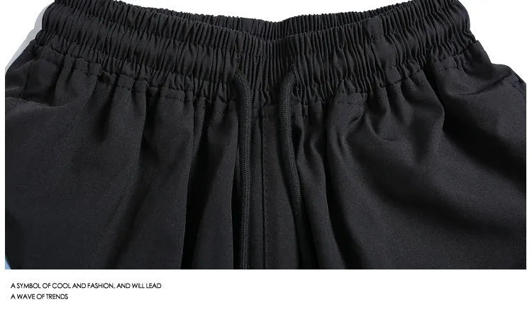 Men's black quick-drying sports shorts with elastic waistband and straight-leg loose fit