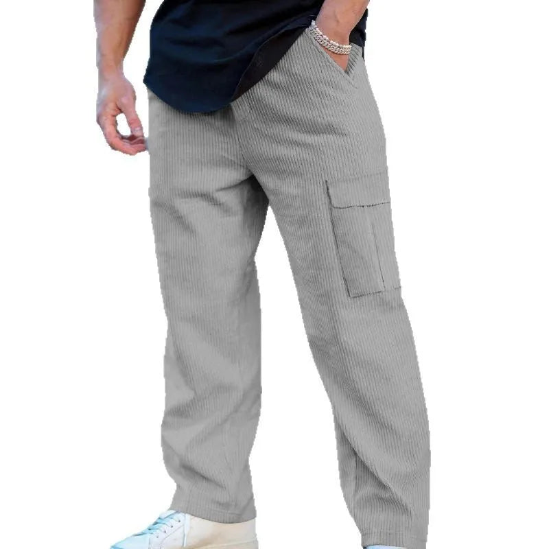 Men's navy blue corduroy cargo trousers with wide-leg design and drawstring waist laid flat.