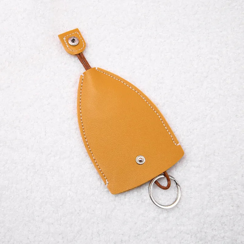 Colourful cartoon pull-out key protector case made from PU leather, showing a selection of fruit and animal designs.