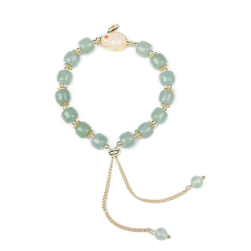 Rabbit charm bracelet with green aventurine stone on copper and gold chain.