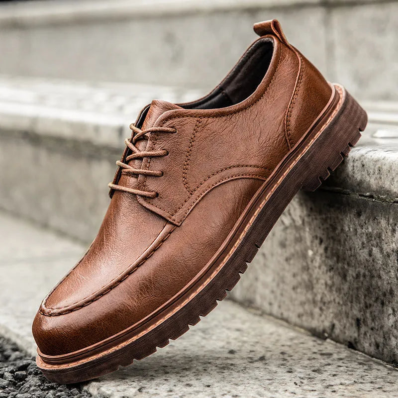 Men's brown leather casual shoes with round toe and flat rubber sole on a white background