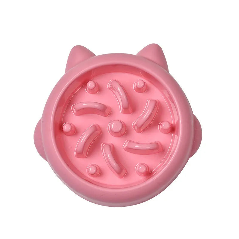 Green plastic slow feeder dog bowl with raised bone-shaped ridges inside.