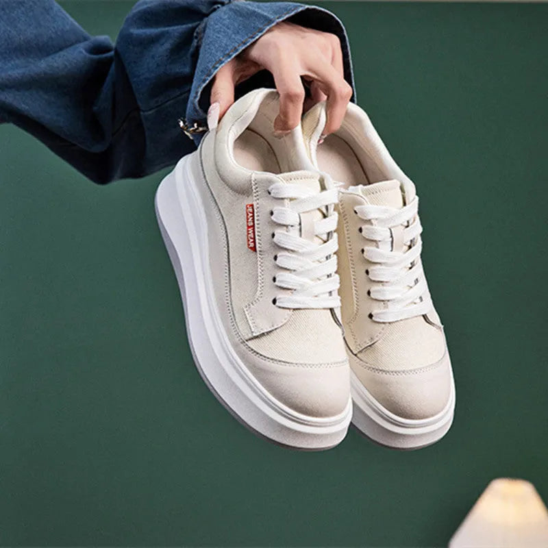Women's beige and pink leather platform shoes with thick soles, shown from the side.