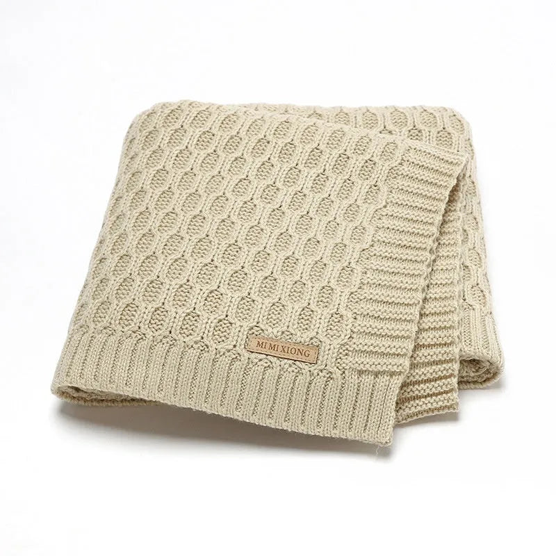 Solid colour infant hug blanket with textured lines, shown in a light green colour.